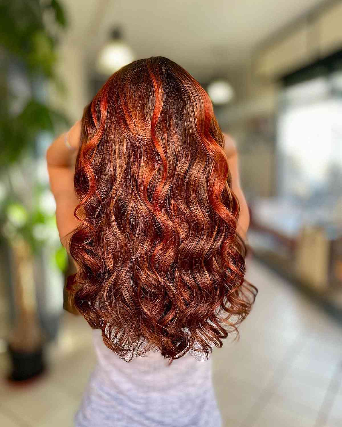 Vibrant copper red hair color at Damyanti Salon